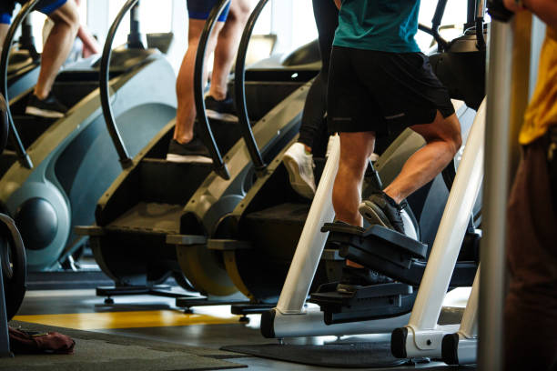 Small group of unrecognizable athletes using exercise machines at the gym
