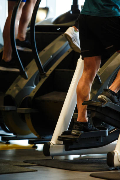 istock Lower section of male athlete using elliptical machine 1241280517