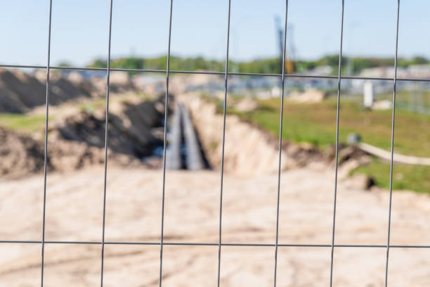 istock construction work, foundation pit with pipes, fenced, blurry background, focus to the foreground 1241295055