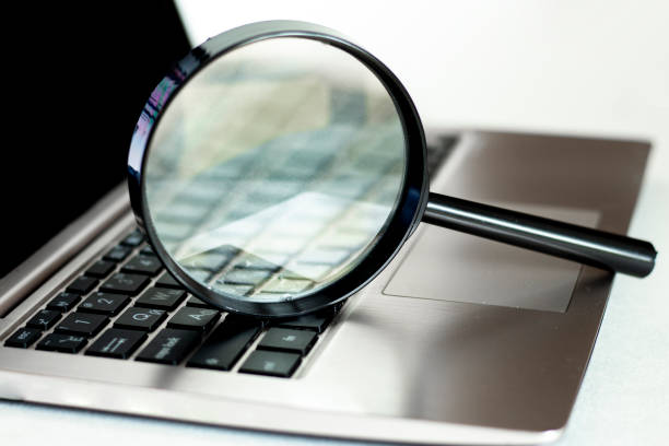 istock Laptop computer with magnifying glass, concept of search. 1241317842
