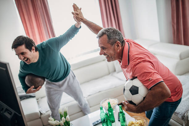istock Smiling fans celebrate the victory 1241326030