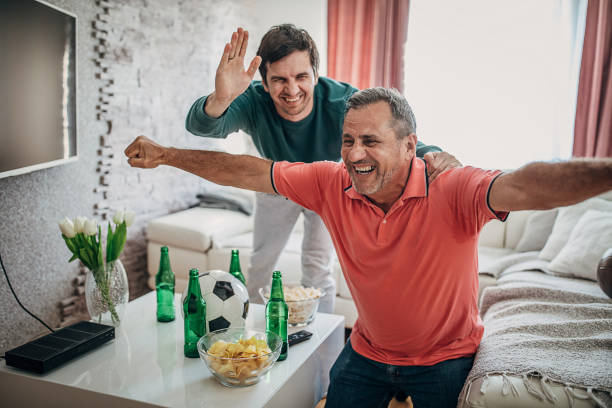 istock Smiling fans celebrate the victory 1241327875
