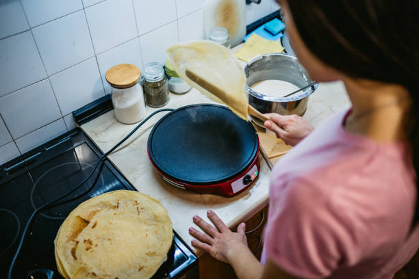istock Woman making pancakes 1241354860