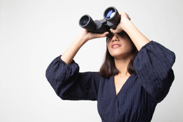 istock Young Asian woman with binoculars. 1241359808