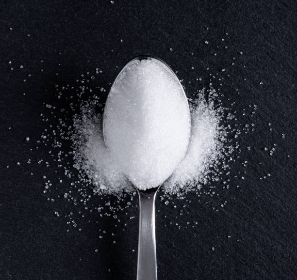 istock Sugar in a spoon placed on a black background 1241363062