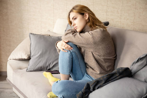istock young beautiful girl resting sitting on a soft sofa bending legs beneath 1241364783