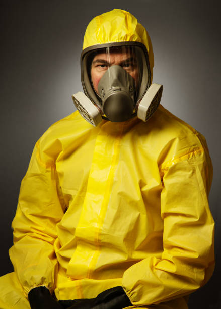istock man wearing a hazmat suit and mask 1241396815