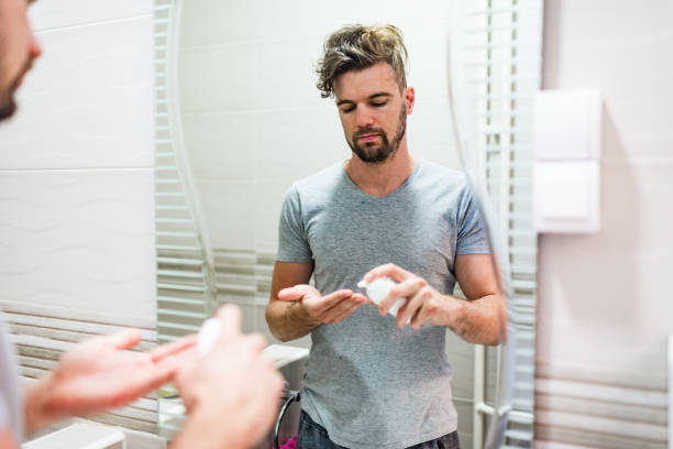istock Young man stylizing his hair in the bathroom 1241402191