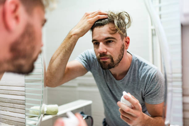 istock Young man stylizing his hair in the bathroom 1241402743