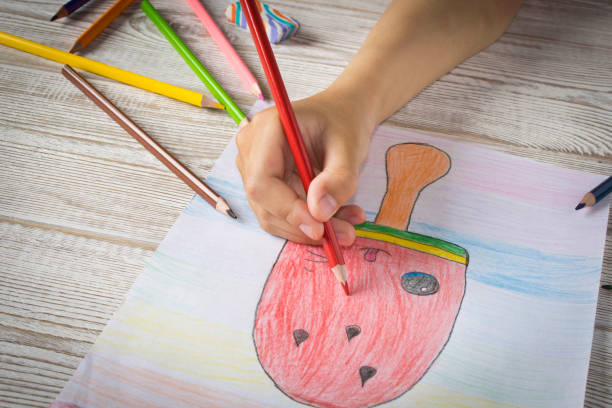 istock The girl draws with colored pencils. Close up. 1241410832