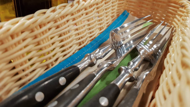 istock The served table in the restaurant. Fork, knife in a brown-yellow wicker pencil case 1241415012