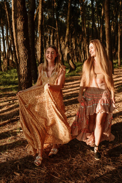 istock Two young woman having fun in the forest 1241415682