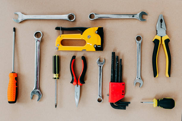 istock Tools top view on craft paper. Plier, open wrenches, screwdrivers and staple gun flat lay. 1241429476