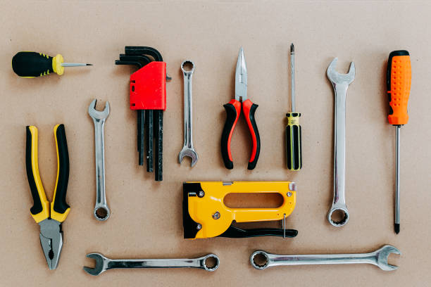 istock Tools top view on craft paper. Plier, open wrenches, screwdrivers and staple gun flat lay. 1241429984