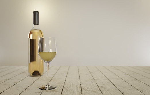Wine bottle and glass on a table with copyspace
