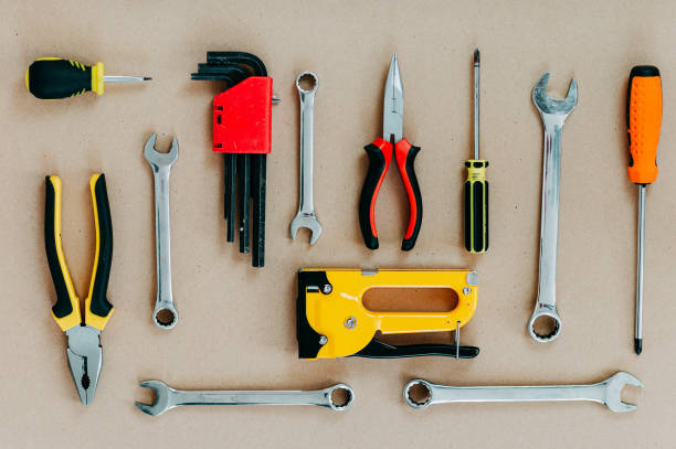 istock Tools top view on craft paper. Plier, open wrenches, screwdrivers and staple gun flat lay. 1241429988