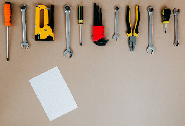 istock Tools top view on craft paper. Plier, open wrenches and screwdrivers flat lay with copy space. Tools and white piece of paper. 1241430017