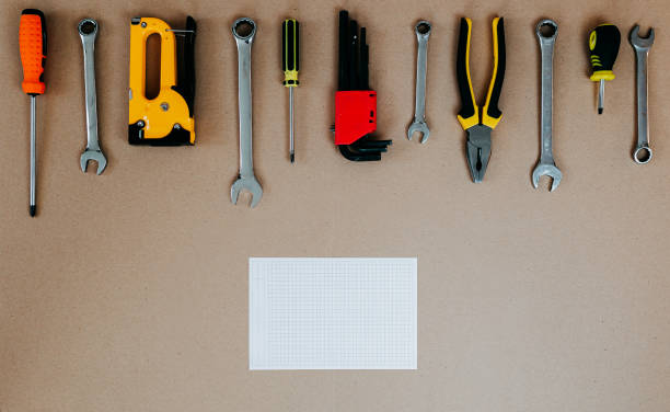 istock Tools top view on craft paper. Plier, open wrenches and screwdrivers flat lay with copy space. Tools and white piece of paper. 1241430636