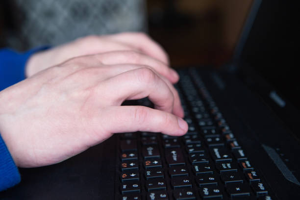 istock Man's hands is typing on the keyboard, closeup 1241436758