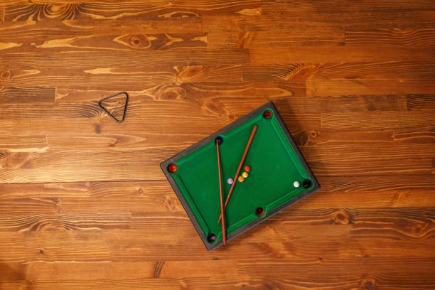 istock Mini billiard table with cue and balls. Mini snooker billiard game. Green billiard table as Leisure and entertainment concept. Top view. Copy space. 1241438388
