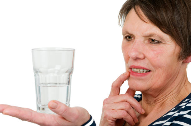 istock Thoughtful look at a glass of water 1241444654