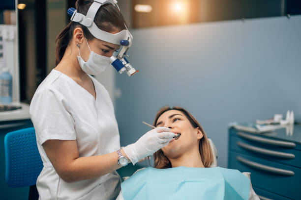 istock careful professional dentist woman treating teeth 1241452588