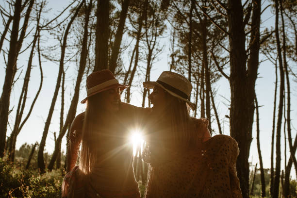 istock Two young woman having fun in the forest 1241457058