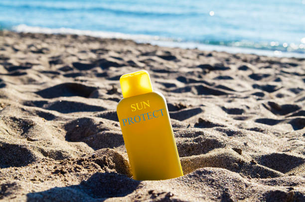 Sun protection lotion bottle on the beach