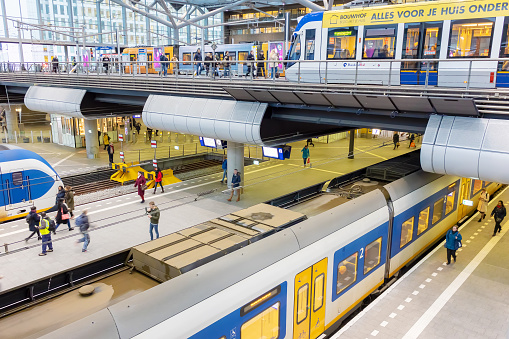 High angle view of blurred motion and light trails of a passenger train in the early evening.