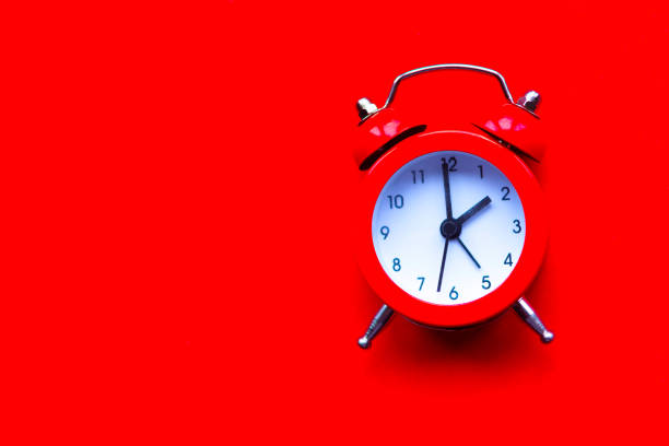 istock Alarm clock on bright red background. Minimal concept. Copy space for the text 1241469712