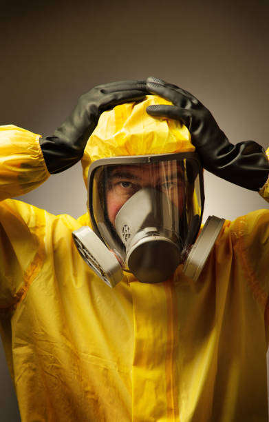 istock man wearing a hazmat suit and mask 1241474303