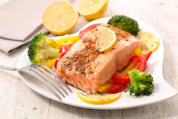 istock baked salmon fillet with vegetable in plate 1241482101
