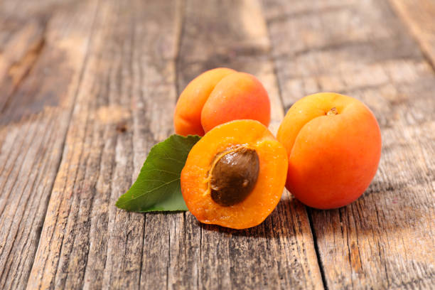 istock fresh apricot and leaf on wood background 1241486550