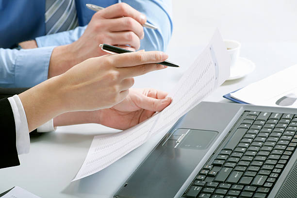 istock Business partners hands working with laptop and papers 124149025