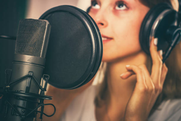 female voiceover speaker in recording studio - voice over imagens e fotografias de stock