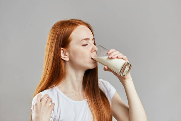 istock pleasant ginger girl is drinking cocktail . close up side view shot 1241495595