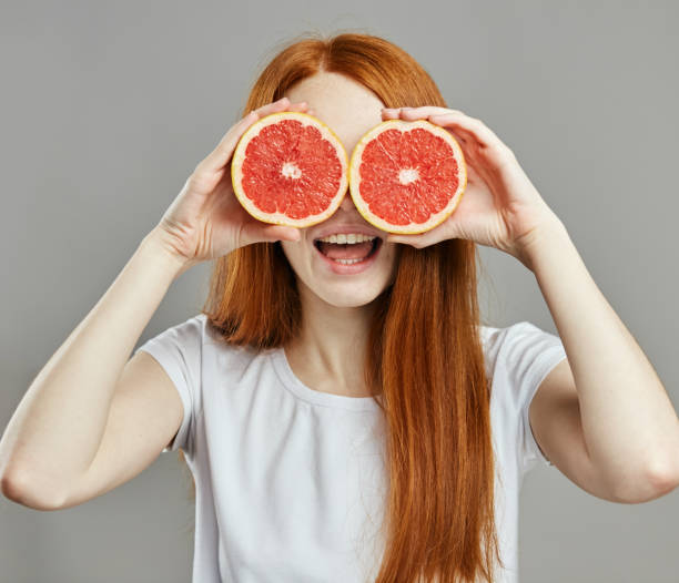 istock happy ginger girl with glasses from fruit 1241496160