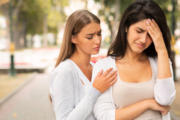istock Compassionate Friend Supporting Crying Girl Standing In Park 1241498380
