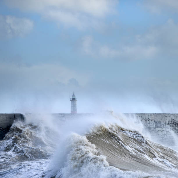 istock Massive waves crash over harbour wall onto lighthouse during huge storm on English coastline in Newhaven, amazing images showing power of the ocean 1241501121