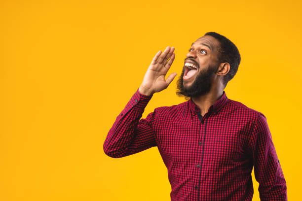 istock Afro guy holding hand near mouth, screaming aside 1241502965