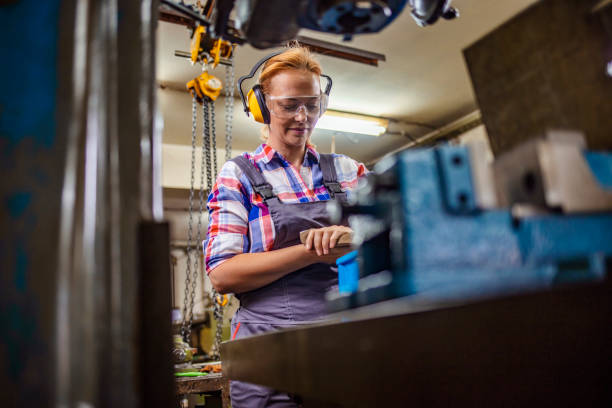 istock Professional craftswoman in industrial factory workshop 1241505134
