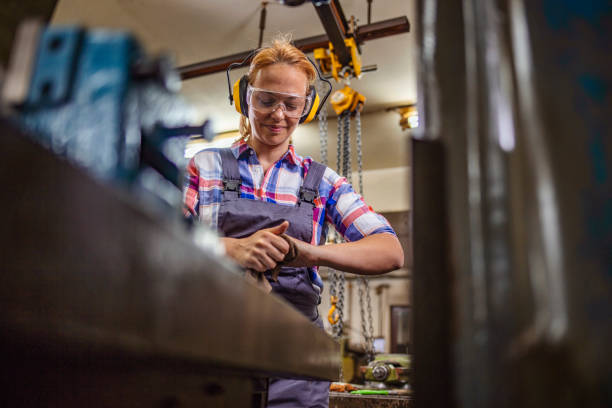 istock Mature craftswoman working on metal in workshop 1241505656