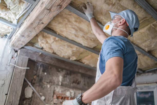 Replacing Old Attic Mineral Wool Insulation. Caucasian Contractor Worker in His 30s Replacing Old Attic Mineral Wool Insulation. Wearing Safe Breath Pro Mask. Industrial Home Improvement and Insulation Materials Theme. attic photos stock pictures, royalty-free photos & images