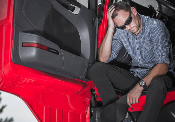 istock Out Of Work Trucker Sitting In Vehicle. 1241526096