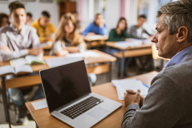 istock Serious professor teaching a lecture at high school. 1241526652