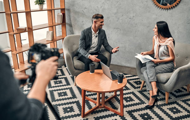Female journalist interviewing business man