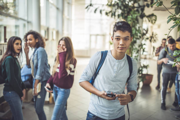 istock Male high school student in a school hallway. 1241529323