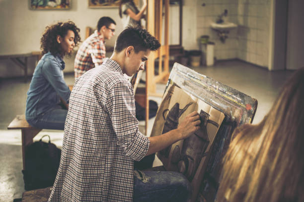 istock Group of art students drawing paintings at art studio. 1241533576
