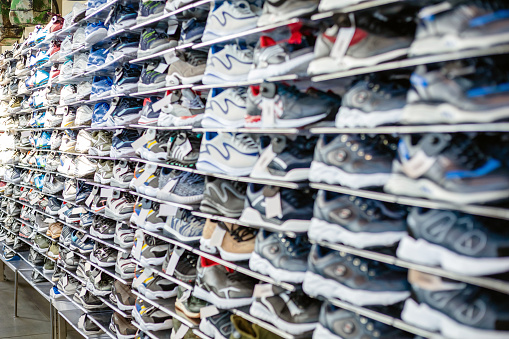 assortment of sneakers on a shelf in a store