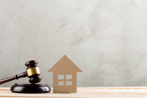 Real estate sale auction concept - gavel and house model stock photo